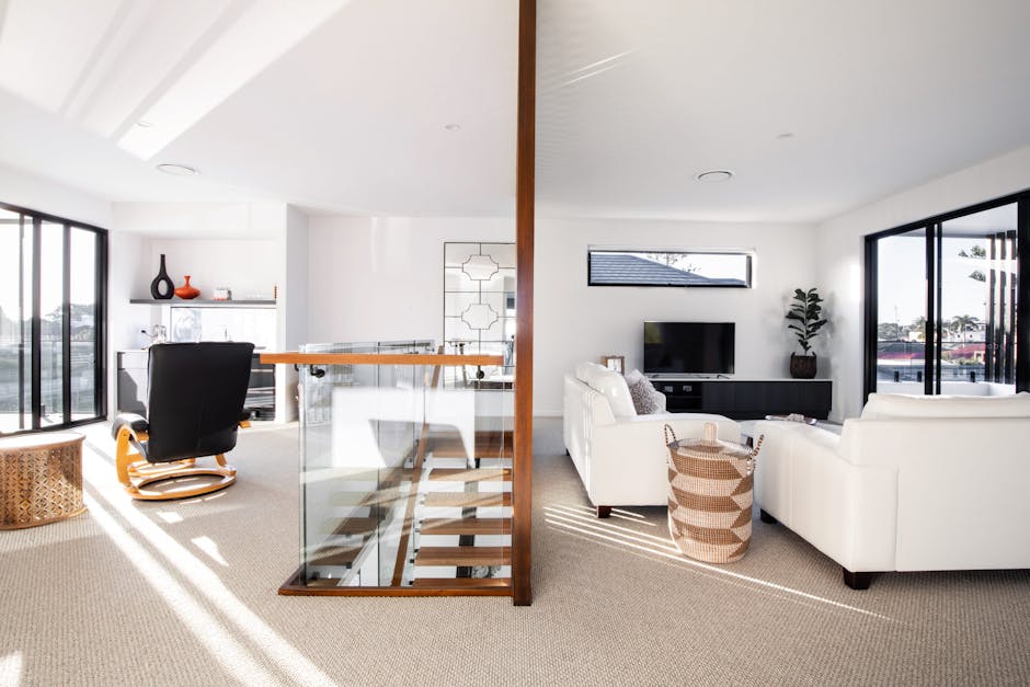Spacious modern living room with stylish furniture and abundant natural light.